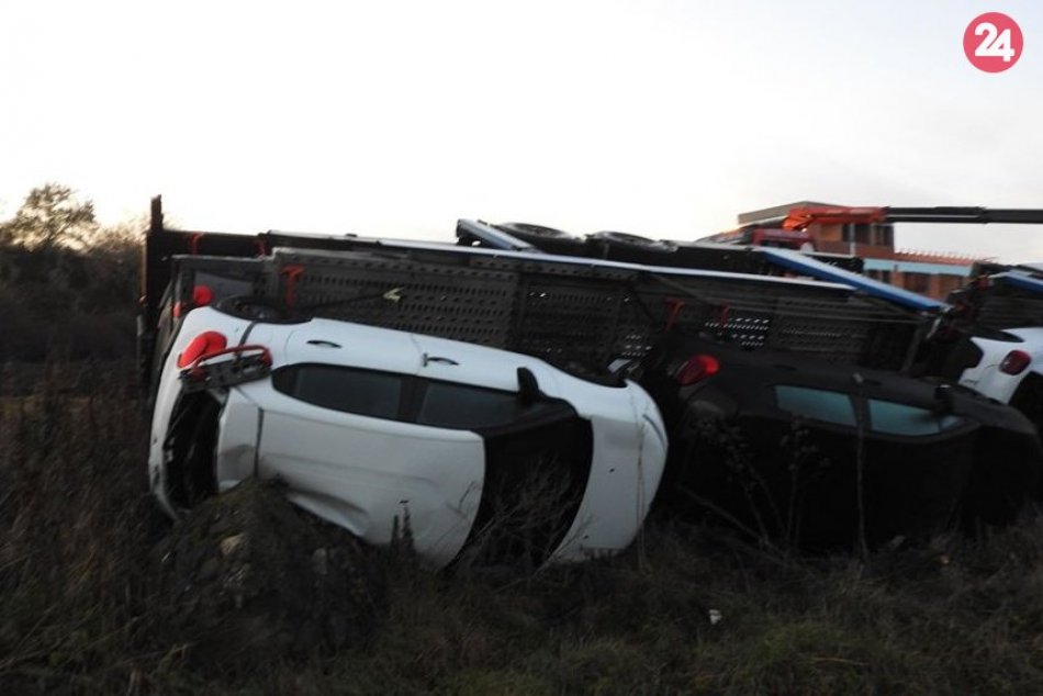 Kamión naložený autami skončil mimo cesty